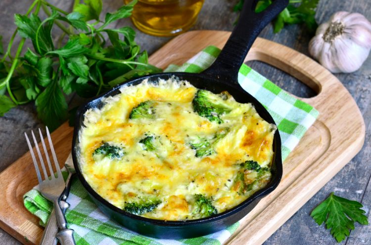 Frittata with potato and broccoli in a frying pan.